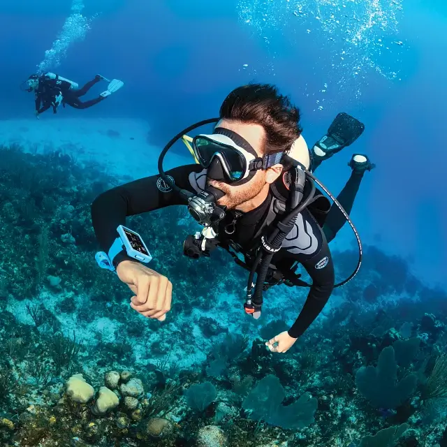 Two scuba divers giving an 'okay' sign underwater